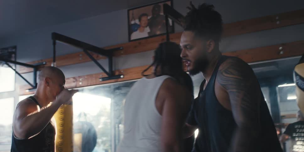 Male friends at a gym greeting each other