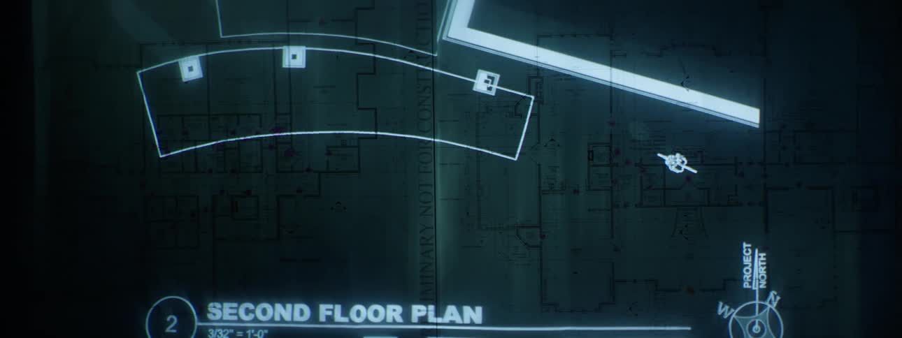 Highlights of a blueprint being projected onto the image of another blueprint