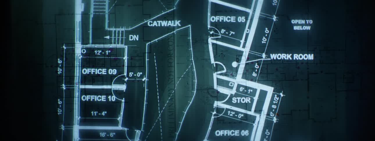 Close up of slides being projected onto a wall with a blueprint