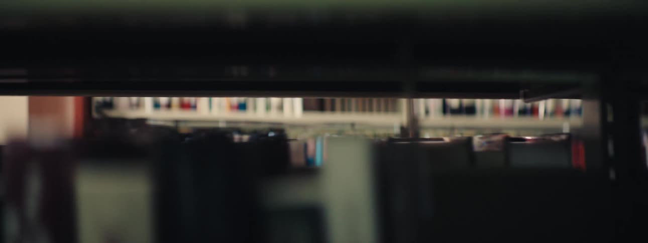 Closeup of an aisle full of books on shelves in a library