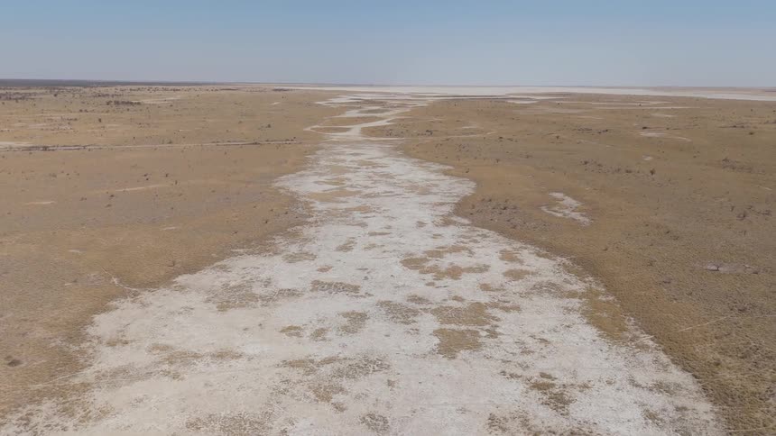 The landscape is flat and covered with sand