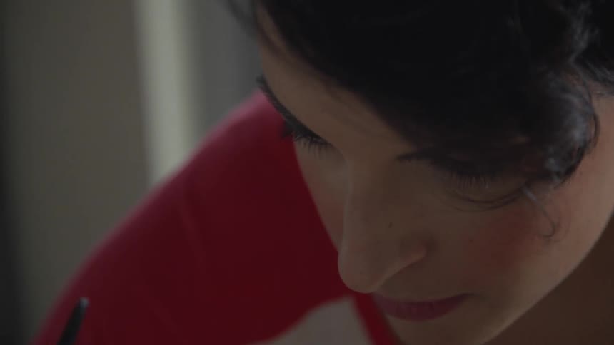 Woman looks down in concentration