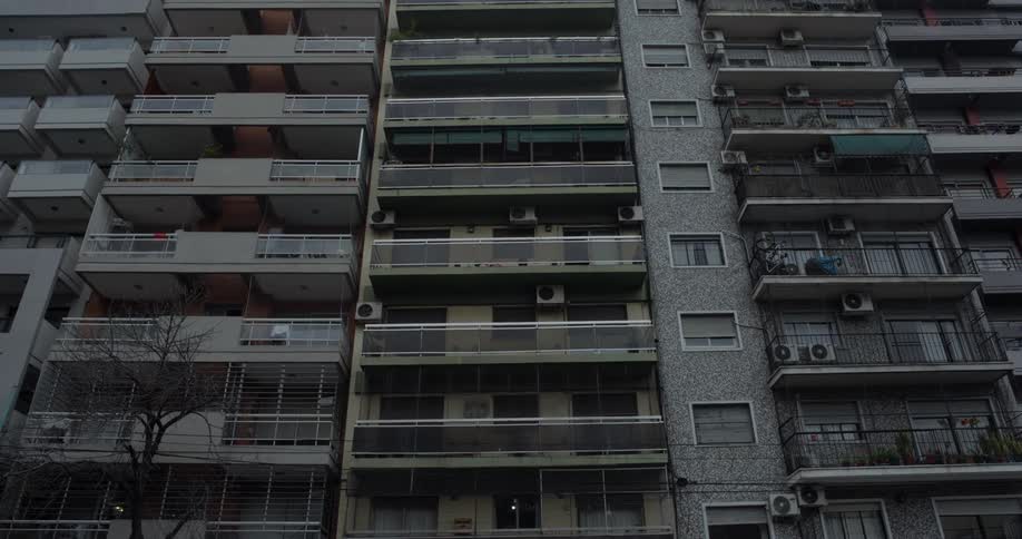 A building with numerous apartments and balconies in a city in the winter