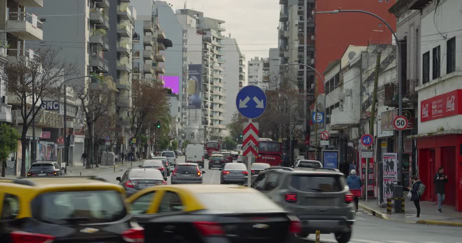 Street with heavy traffic surrounded by buildings in a metropolis