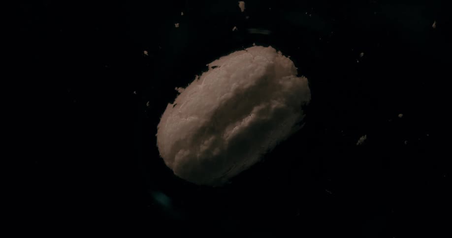Extreme close up of a white pill slowly dissolving