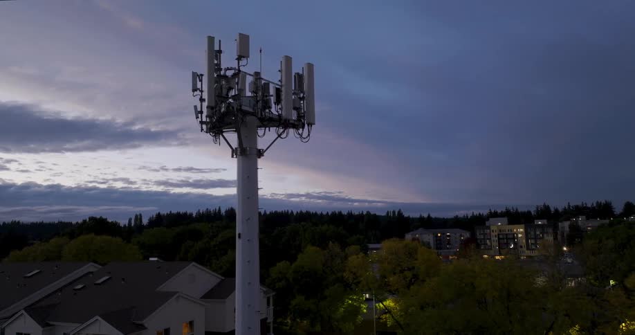 Cellular communications network antenna over an urban neighborhood with townhomes and apartment buildings