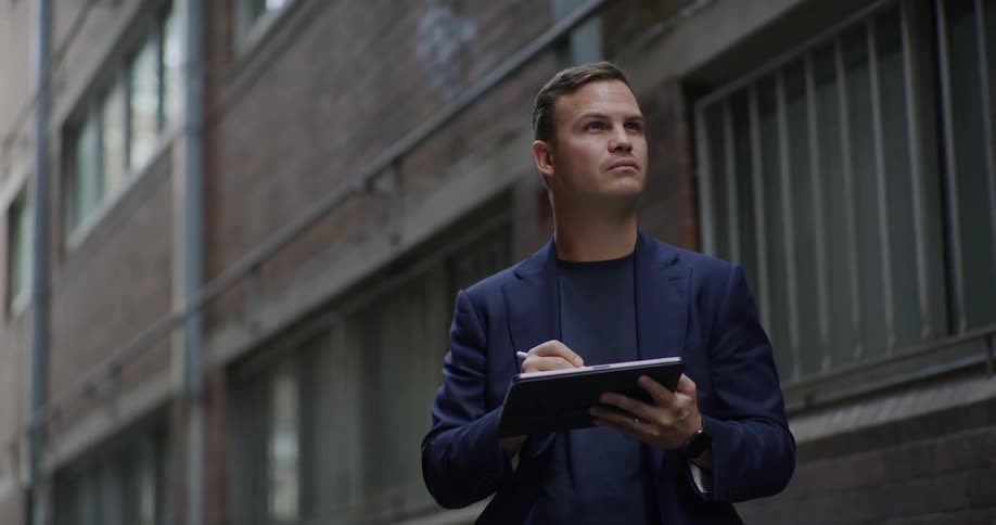 A clop of a man keeping records on a tablet