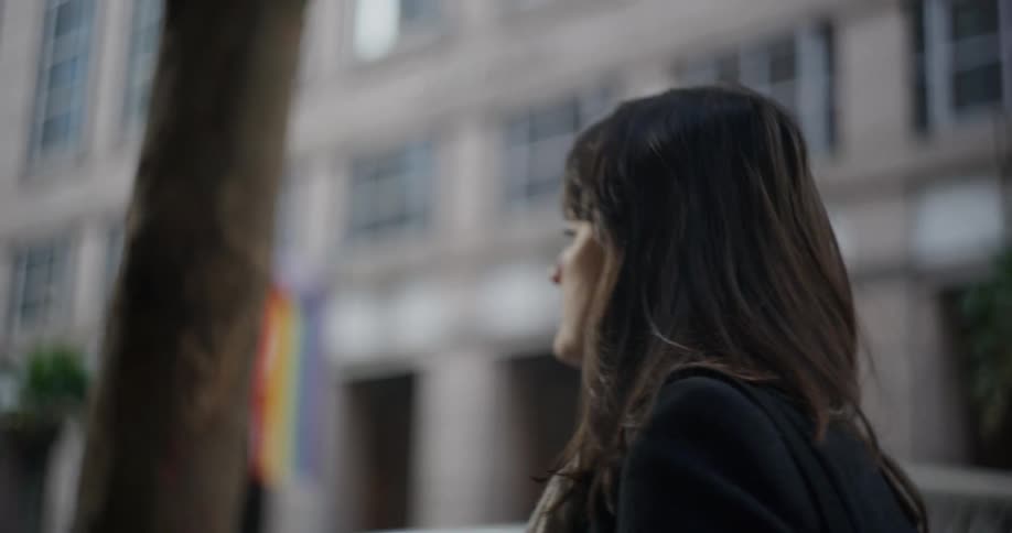 Black haired woman walking in a metropolis