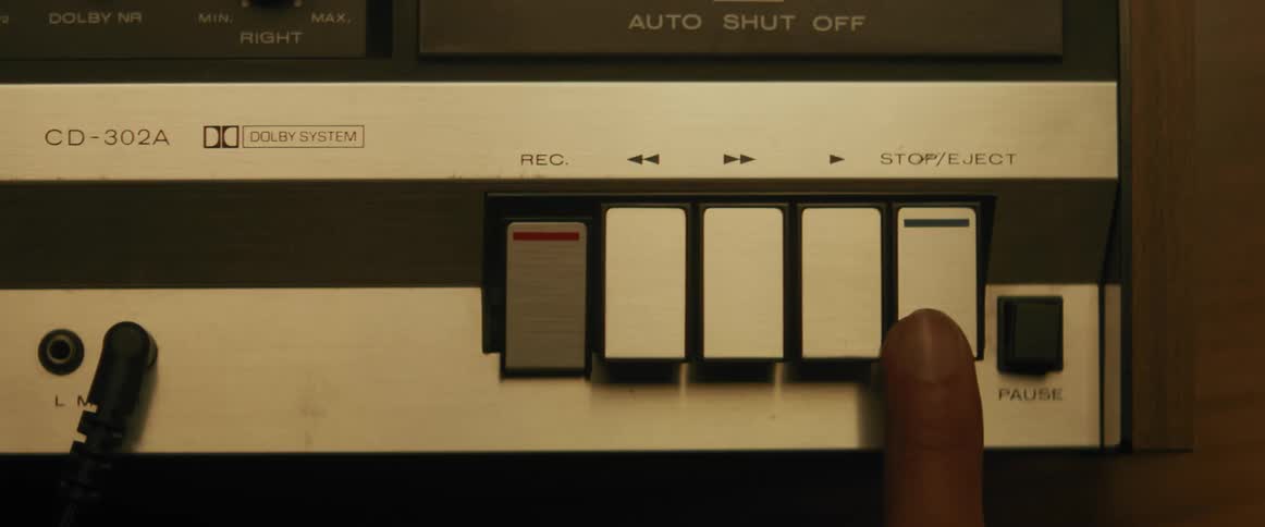 Person presses the stopeject button on a tape recorder