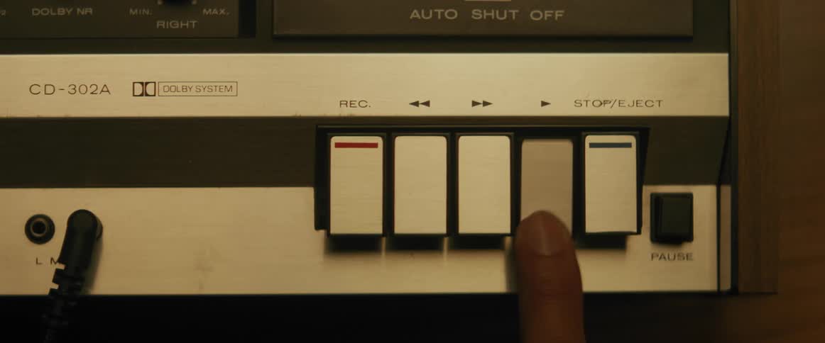 A person presses play on the tape recorder