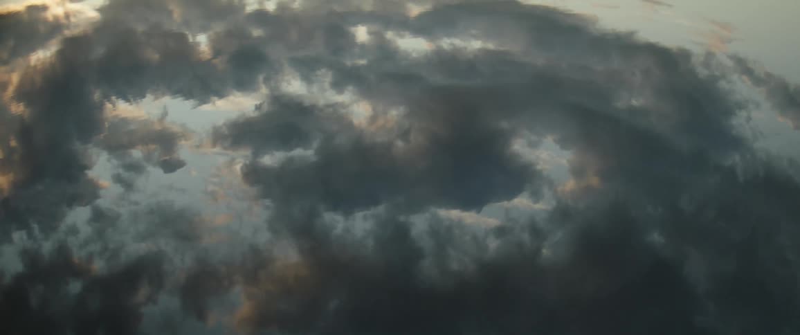 Calm lake reflecting a cloudy sky