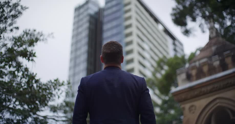A back view of a man looking at a building
