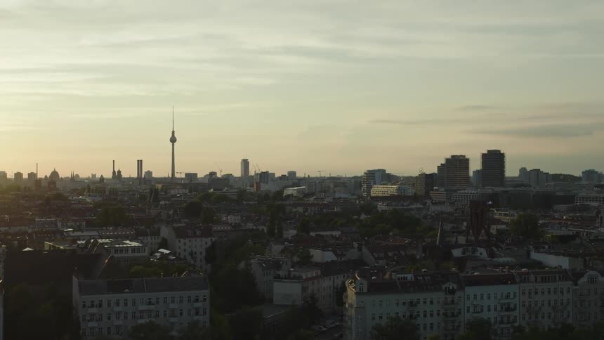 A panoramic view of the toronto skyline as the sun sets casting a golden light over the cityscape