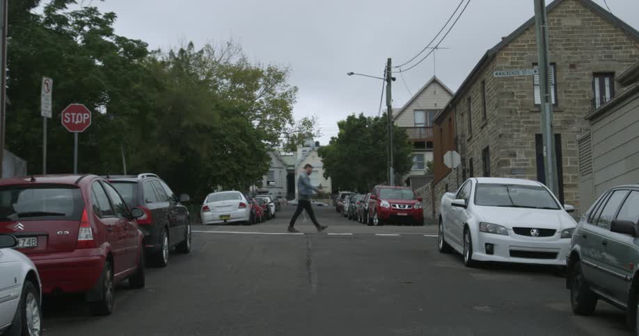 Man crosses a street at a crosswalk