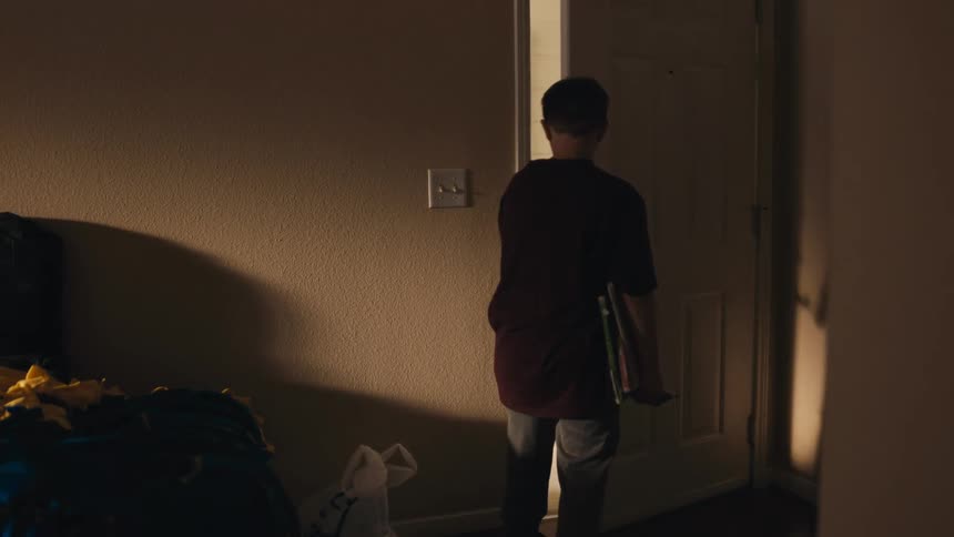 Boy leaving a room in the house and closing the door