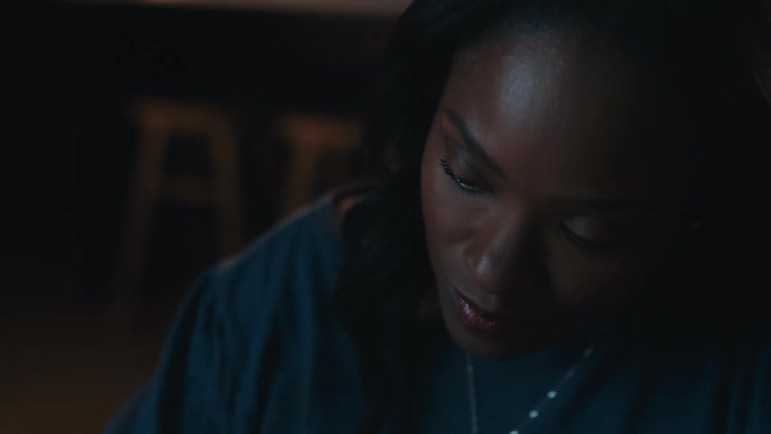 A close up clip of a black lady contemplating
