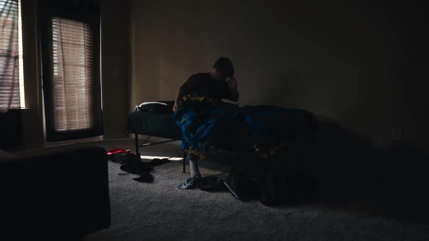 Teenager waking up and getting out of bed