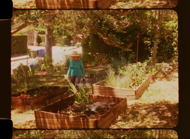 Woman in the garden of a backyard of a house
