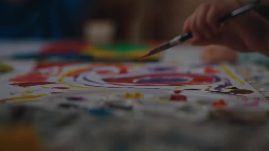 A kid paints a picture