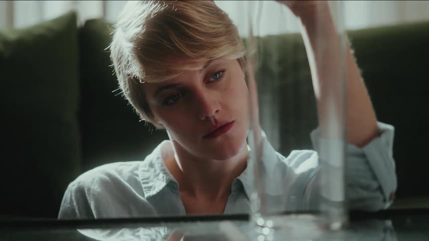 Thoughtful woman staring into a glass jar