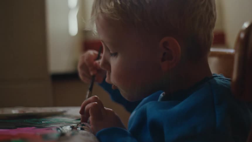 A boy paints a picture