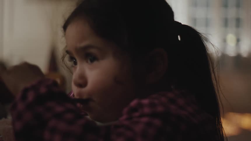 Close up of a toddler eating cereal from a bowl at home