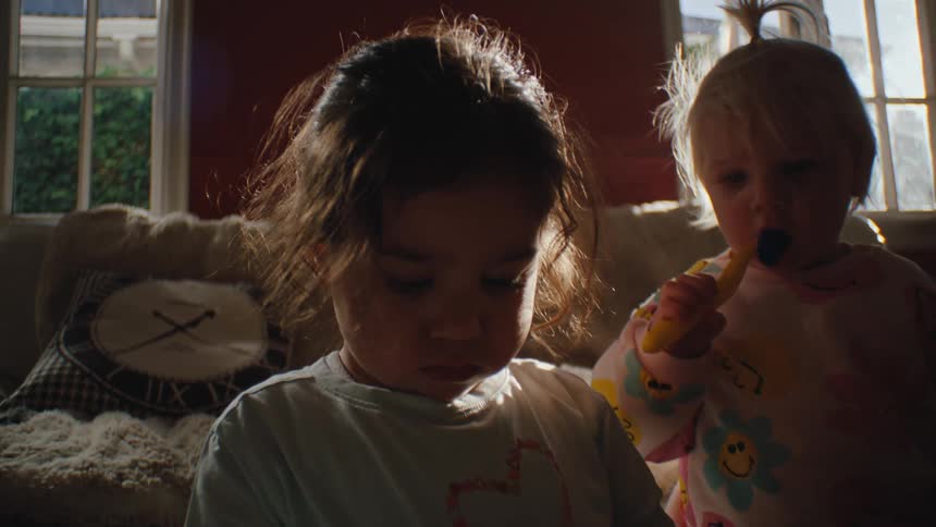 Two small children playing in the living room