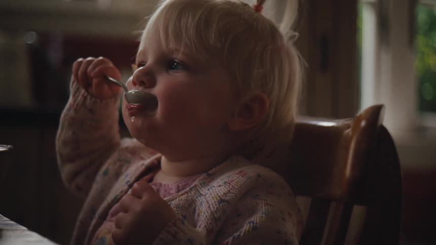 A child is eating at home