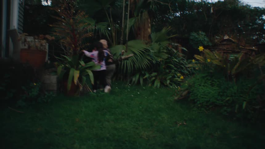 A couple of children running around in the backyard