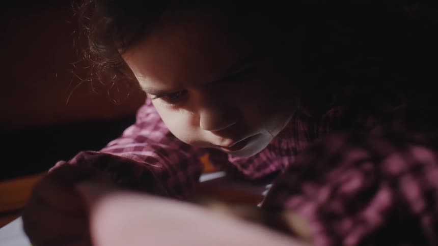 Portrait of a little girl lying on her stomach