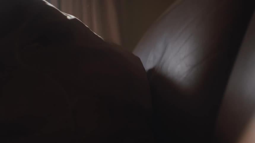 A woman gets under the covers