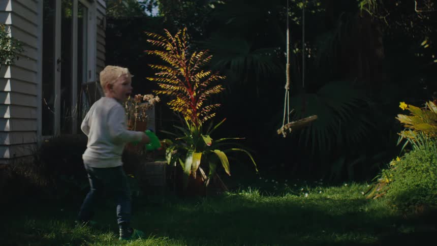 A child is running and squirting a watergun