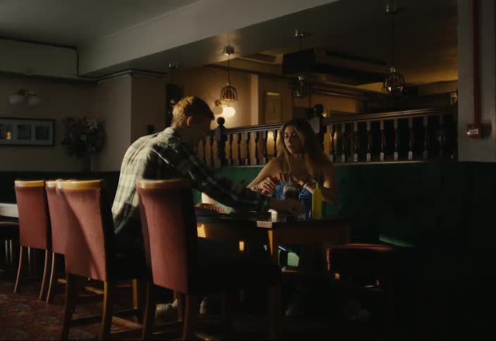 Man and woman sitting at a restaurant table eating