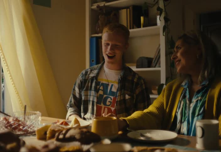 Man and woman sitting at the table laughing as they talk