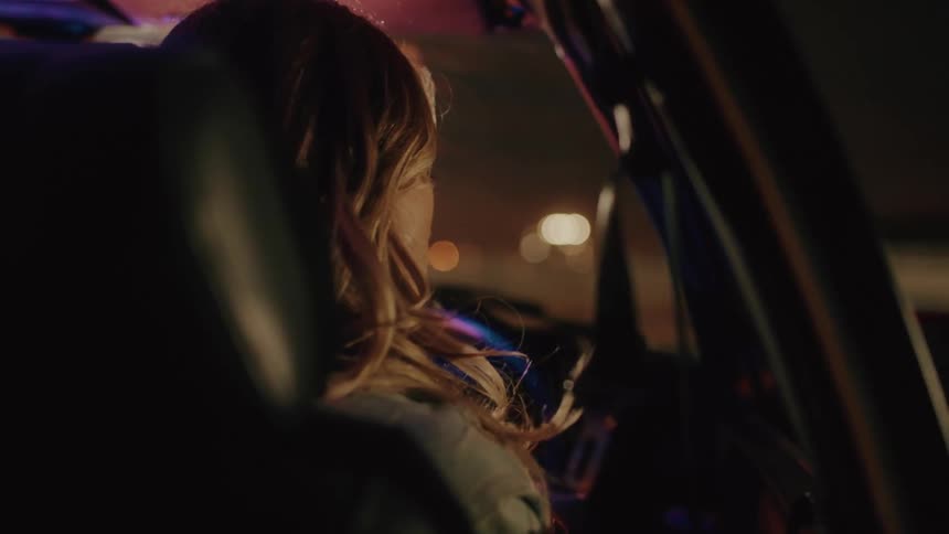 Woman opening the door and getting out of the car