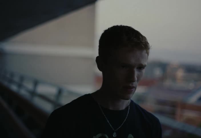 Man talking on the balcony of a building