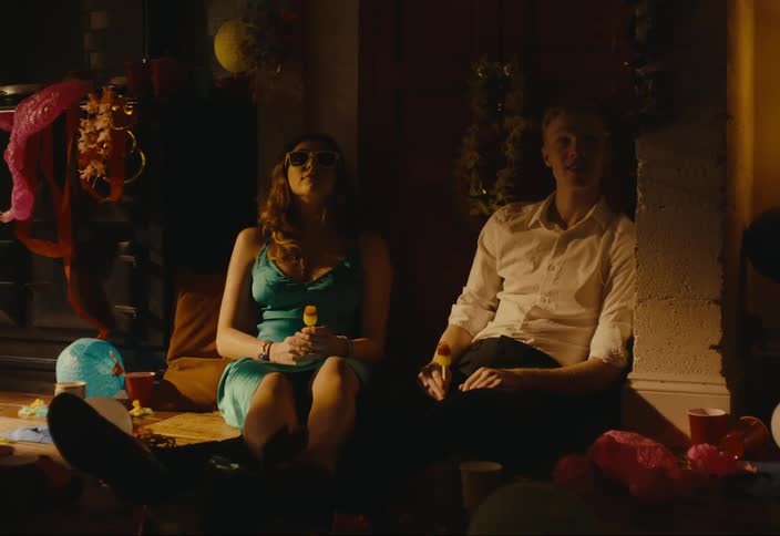 Man and woman sitting in a party setting