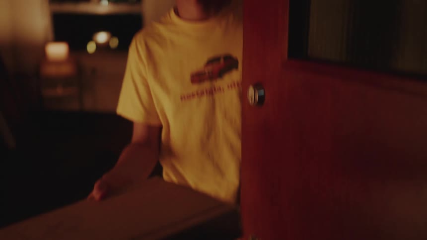 A pizza is delivered to a customer at night