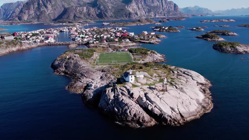 An aerial view of a small island with a soccer field in the center