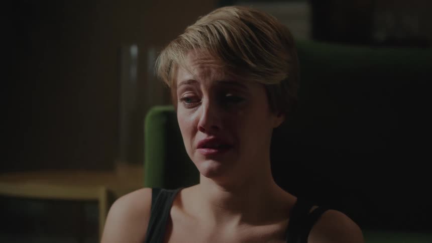 Portrait of a young blonde woman crying