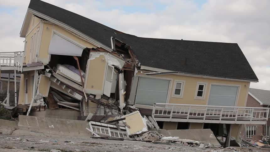 A view of a partially demolished yellow house