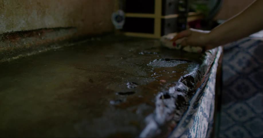 Womans hand cleaning the sink