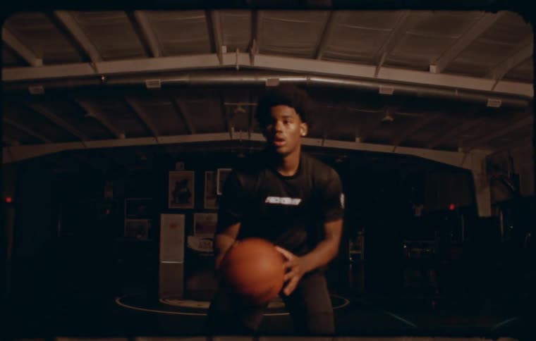 A clip of a teenager freestyling with a basketball