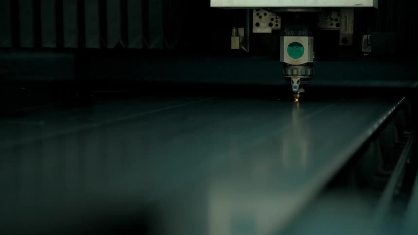 Closeup of an industrial machine a laser cutter in operation
