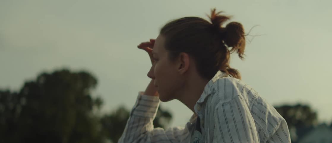 Woman with hand on forehead watching