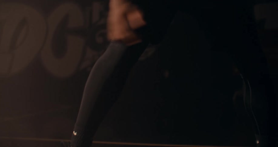 Close up of a young mans legs showing off his handling skills with a basketball