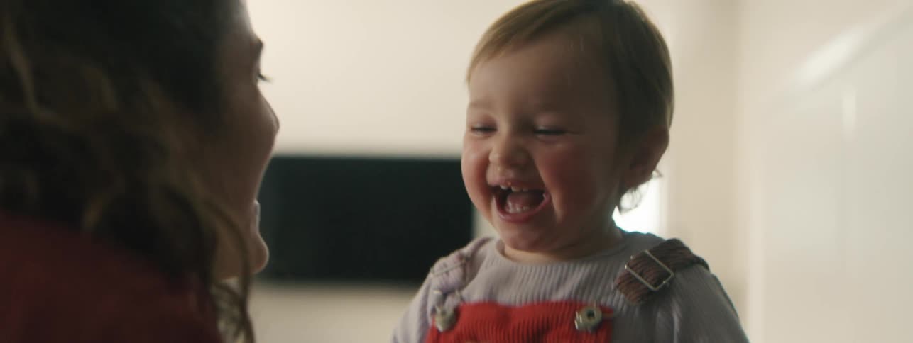 Mother and little daughter playing together and laughing