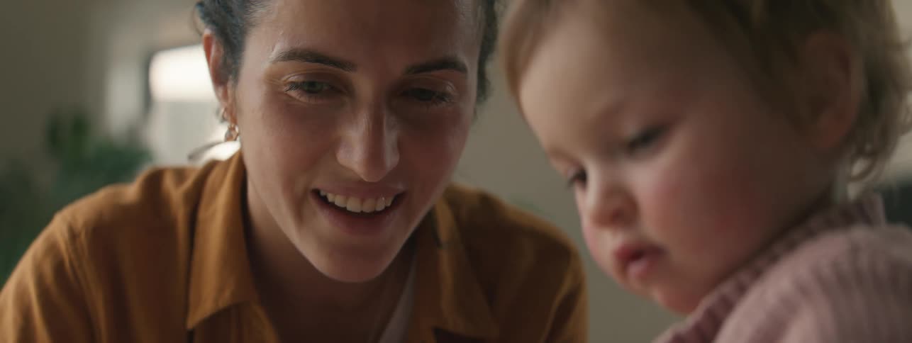 Mother and daughter playing in the living room at home
