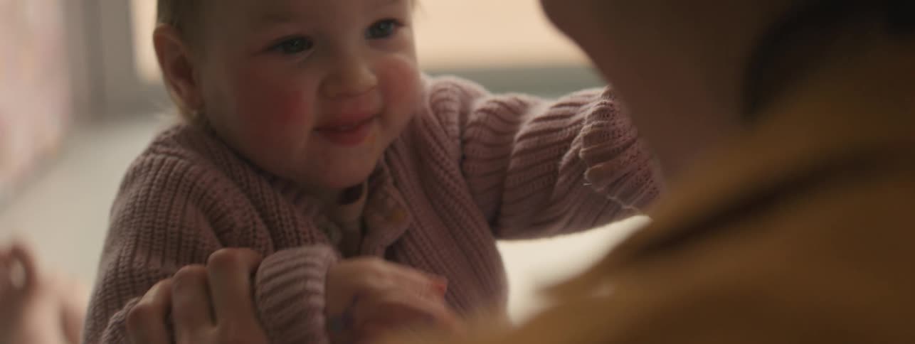 Mother playing with her excited little daughter
