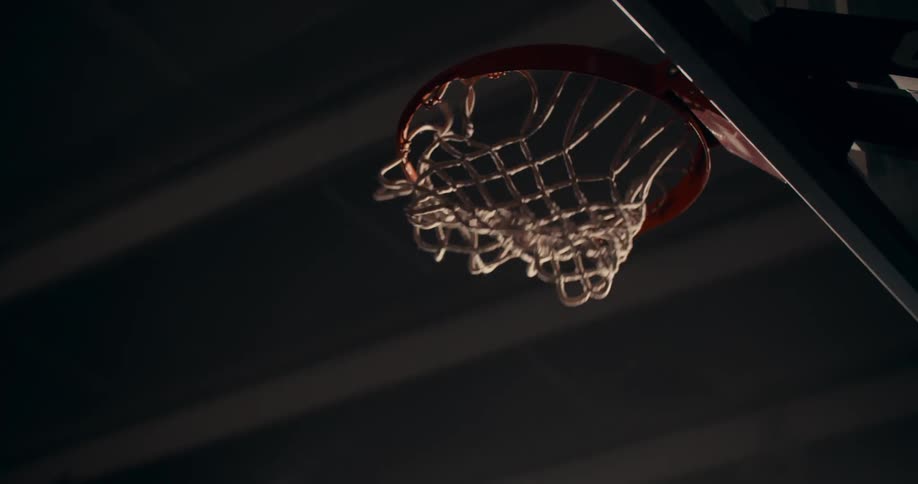 A basketball passing through a basketball hoop